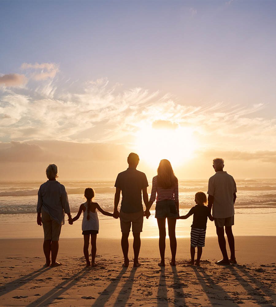 Family on beach during sunset