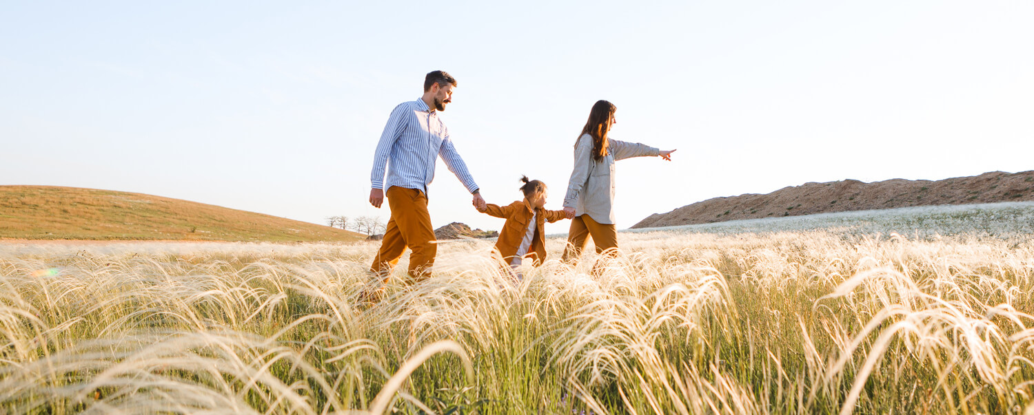 A family walking in a field, confident in their family trust