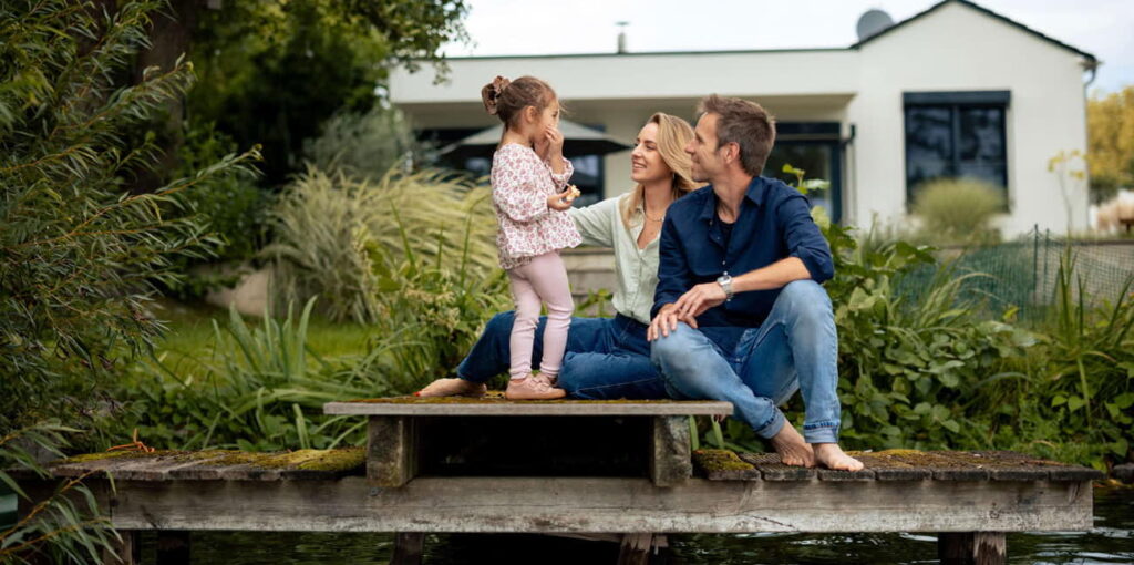 Parents with a child on a dock interacting happily