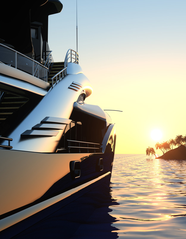 Yacht on the water with an island and sunset behind it