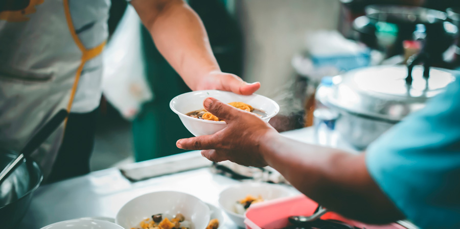 Volunteer handing out food to the less fortunate